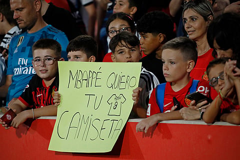 La Liga, Real Madrid vs Mallorca: A young Real Madrid fan, 3rd left holds a sign asking for Real Madrid's Kylian Mbappe's shirt 